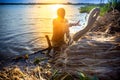 A worker cleans decomposing jute-fibers on the river water in the evening time at Rajrajeshor, Royalty Free Stock Photo