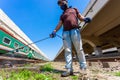 An employee sprays disinfectant on a outside of train as a precaution against a new at Royalty Free Stock Photo