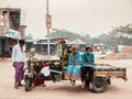 Bangladesh people family on motor rickshaw tricycles on Dhaka city street