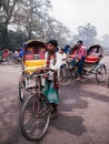 Bangladesh people and rickshaw tricycles driver on Dhaka city busy street