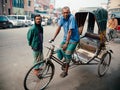 Bangladesh people and rickshaw tricycles driver on Dhaka city dusty street