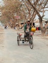 Bangladesh people and rickshaw tricycles driver on dirt road of Dhaka suburb area