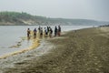 Bangladesh - Small group of people fishing in river with net