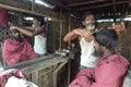 Bangladeshi barber at work in barbershop in Dhaka