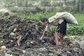 Bangladeshi boy take useful goods from landfill Royalty Free Stock Photo