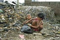 Bangladeshi children take useful goods from landfill Royalty Free Stock Photo
