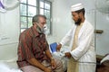 Bangladeshi doctor working in hospital with patient