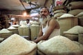 Bangladeshi rice seller at stall on indoor market