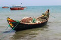 Bangladeshi traditional fishing boat on St. Martin`s Island. Fisherman preparing boat for sailing into the ocean. Royalty Free Stock Photo