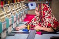 Bangladesh Ã¢â¬â August 6, 2019: A Bangladeshi woman garments worker working with Computerized Embroidery Machine at Madhabdi,