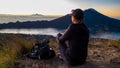 Bangli - A woman enjoying the sunrise on Mt Batur