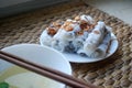 Banh cuon-vietnamese steamed rice rolls with minced meat inside accompanied by bowl of fish sauce.