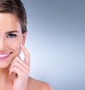 Banish bad skin days for good. a young woman applying moisturizer to her face.