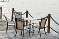 Banister railing on marine rope and wood with table and chairs on Turkey Mediterranean sea