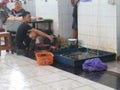 Banjarbaru Indonesia: 27 December 2021: fish seller sell many fishes on basket. They wait a costumers