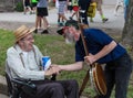 Banjo Player with Man in Wheelchair at Iowa State Fair Royalty Free Stock Photo