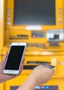 Bank ATM Auto Teller Machine with customer user person using credit card, or debit card and smartphone for paying cash payment Royalty Free Stock Photo