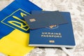 Bank card with chip, flag and Ukrainian passport on light background Royalty Free Stock Photo