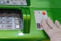 Bank card Mastercard in a hand in a medical protective glove on a background of an ATM. Russia, Tatarstan, March 31