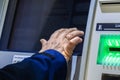 Bank client interacting with an ATM touchscreen interface, selecting options on cashpoint display. Closeup of clients hand Royalty Free Stock Photo