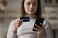 Bank customer girl using mobile phone, holding credit card