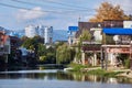 The bank of the Dagomys river is built up with small cottages with garages for boats, high-rise buildings and mountains on the