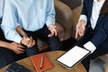 Bank employee holding tablets for customers to see solutions in choosing investments