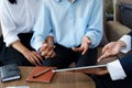 Bank employee holding tablets for customers to see solutions in choosing investments