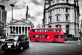 Bank of England, the Royal Exchange in London, the UK. Black taxi cab and red bus.