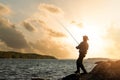 Bank fishing. fisherman with spinning rod at sunset. copy space Royalty Free Stock Photo