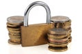 Financial security concept with stacks of coins and padlock on white background Royalty Free Stock Photo