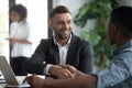 Happy manager shaking hands with client in modern bank office Royalty Free Stock Photo