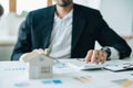 Bank loan workers are using calculators to calculate home loan interest rates for customers to assess their investment Royalty Free Stock Photo
