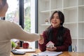 The bank mortgage officer or real estate agent handshake with customer deal after signing a house insurance, loan Royalty Free Stock Photo