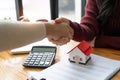 The bank mortgage officer or real estate agent handshake with customer deal after signing a house insurance, loan Royalty Free Stock Photo