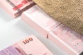 Bank notes of 100 Thai baht inside agriculture sack Royalty Free Stock Photo