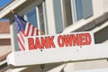 Bank Owned Real Estate Sign and House with America Royalty Free Stock Photo