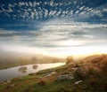 Bank of the river on the background of the rising sun