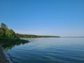 The bank of the river - a calm expanse of water in blue tones