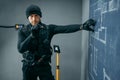 Bank robbery, male robber in black uniform Royalty Free Stock Photo