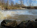On the bank of rocky river in spring sunny day. Royalty Free Stock Photo