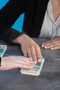 A bank teller accepts money from a client who transfers the cash to be paid into a bank account Royalty Free Stock Photo