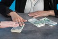 A bank teller accepts money from a client who transfers the cash to be paid into a bank account Royalty Free Stock Photo