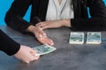 A bank teller accepts money from a client who transfers the cash to be paid into a bank account Royalty Free Stock Photo