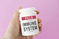 Bank with the text: IMMUNE SYSTEM in hands