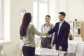 Bank worker, financial advisor or credit broker shaking hands with happy young couple Royalty Free Stock Photo