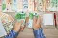 Banker counting Euros at his office table,