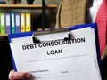 Banker offers Debt consolidation loan documents for filling in.