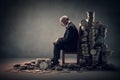 a banker sitting on a chair with a pile of coins