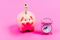 Banking account. Economics and finance. It is time to pay. Piggy bank stuffed dollar cash and alarm clock. Financial Royalty Free Stock Photo